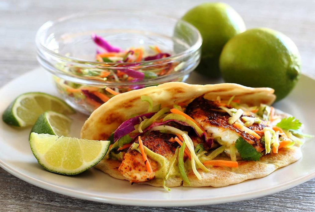 Easy paleo recipe for fish tacos with lime slaw and avocado sauce