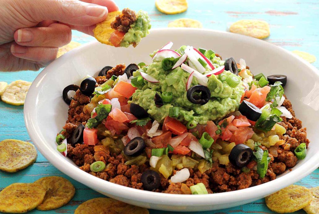 meaty Mexican dip featuring 9 layers of goodness, plus plantain chips for scooping