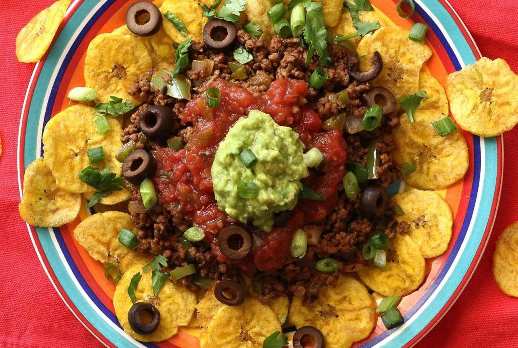 hearty plate of nachos with a spicy meat and veggie dip